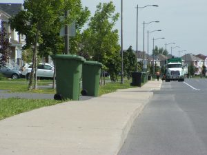 Garbage bins on the sidewalk 