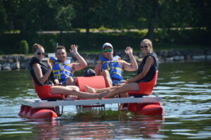 group of friends on a pedalo
